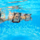 Children under water in swimming pool